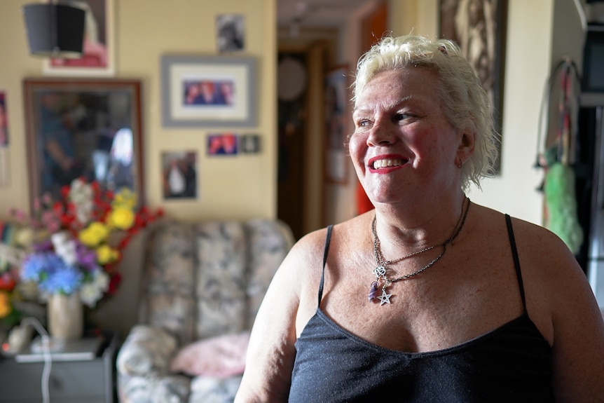 A smiling woman wearing a black top.