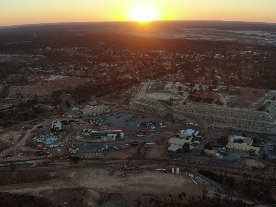 drone shot of mining town at sunset