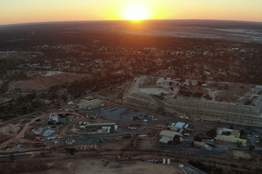 drone shot of mining town at sunset