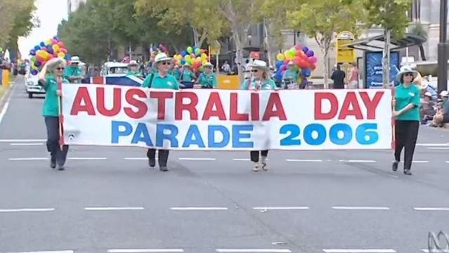 People in parade hold sign that reads "Australia Day Parade 2006"