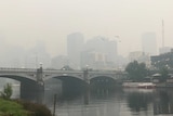 Princes Bridge in Melbourne's CBD is seen in front of a smoke-hazed CBD.