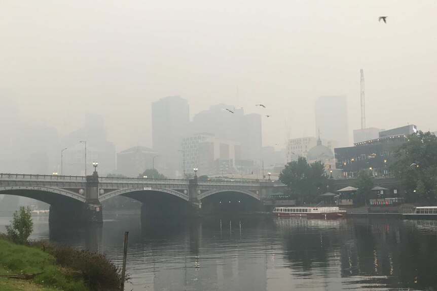 Princes Bridge in Melbourne's CBD is seen in front of a smoke-hazed CBD.