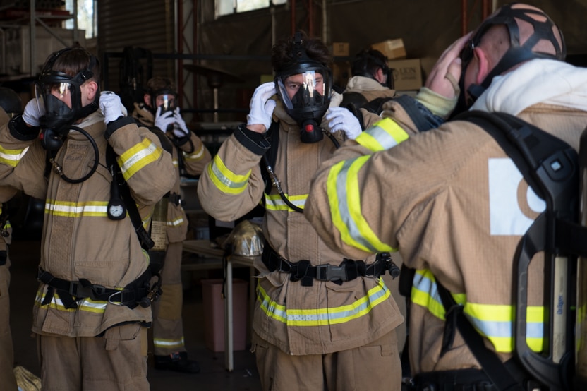 The students put breathing apparatus masks on.