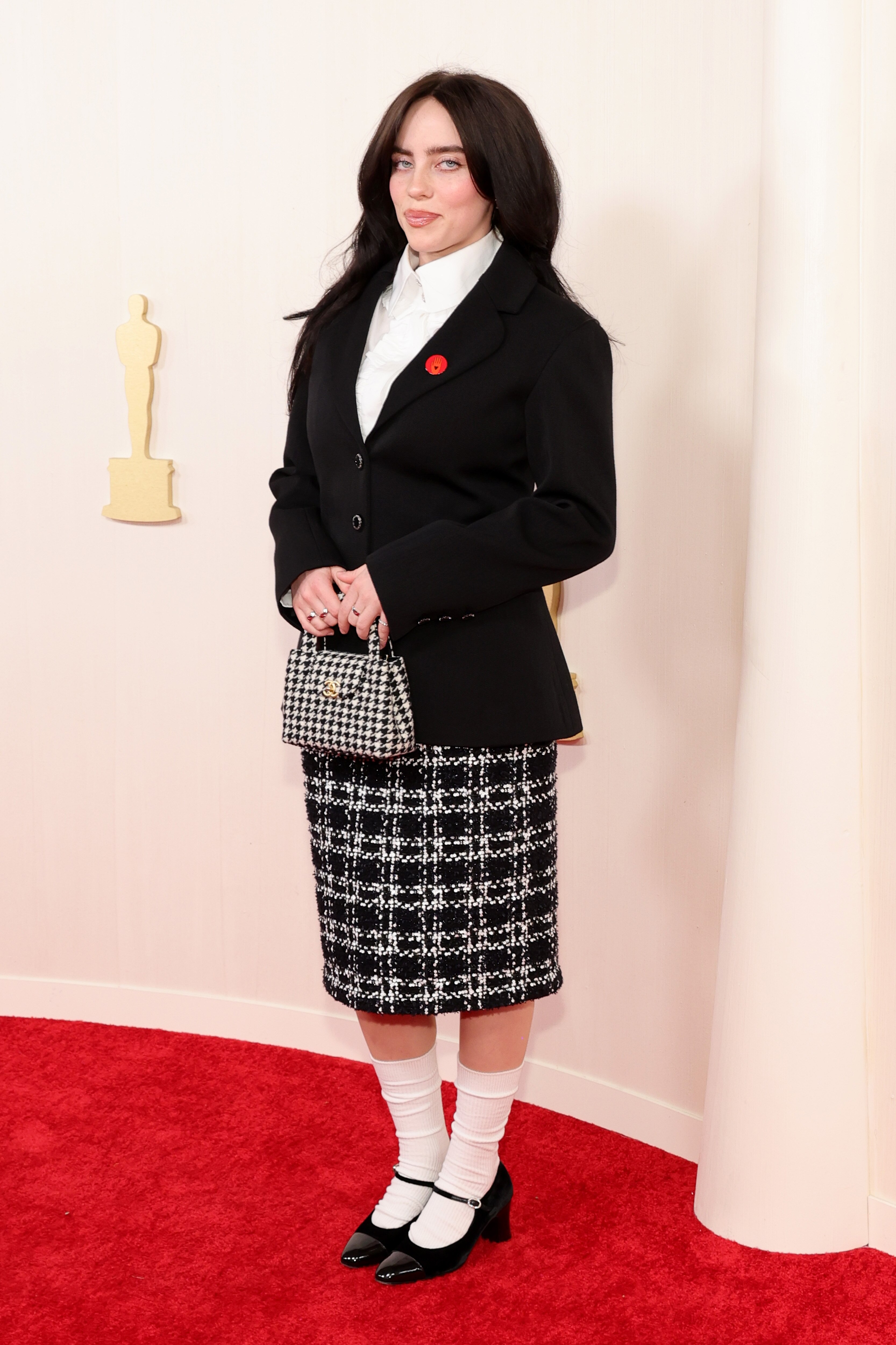 Billie Eilish poses on the Oscars red carpet.