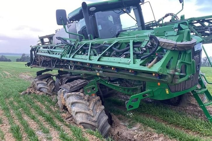 bogged tractor in a paddock