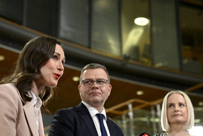 Sanna Marin in foreground next two her election opponents  Petteri Orpo and Riikka Purra.