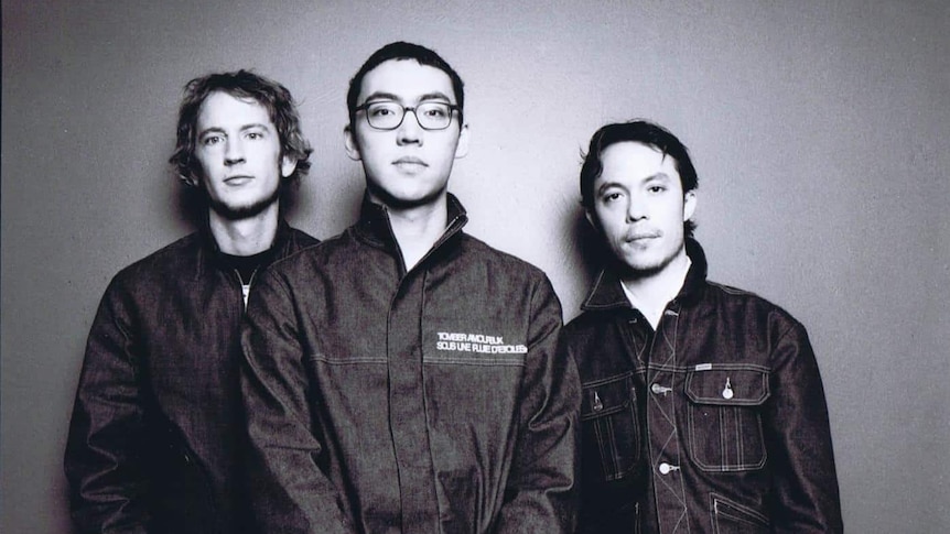 Black and white photo of three members of rock band Regurgitator standing and looking at the camera.