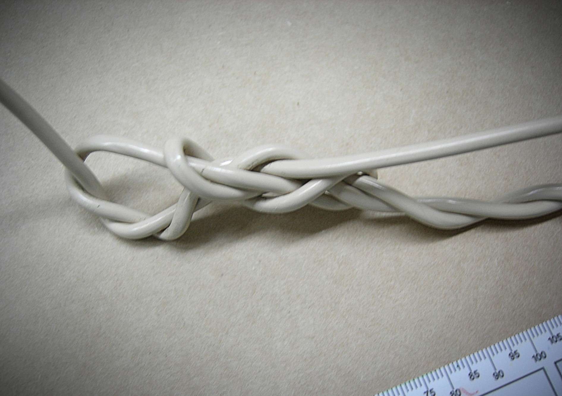 A close up picture of a twisted communications cable