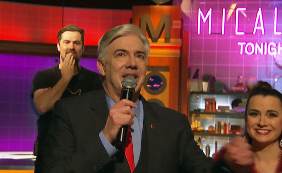 Shaun Micallef tearing up holding a microphone after the taping of his final program in Studio 31.