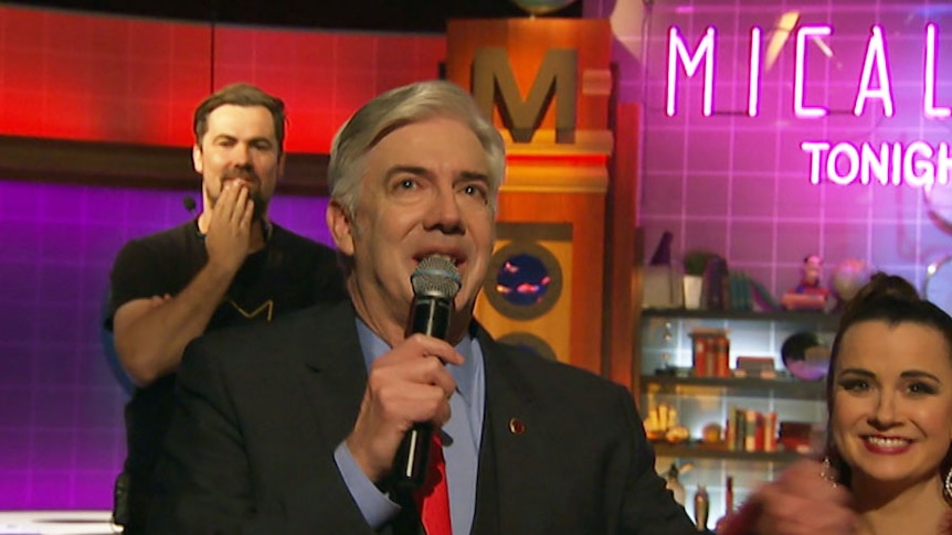 Shaun Micallef tearing up holding a microphone after the taping of his final program in Studio 31.