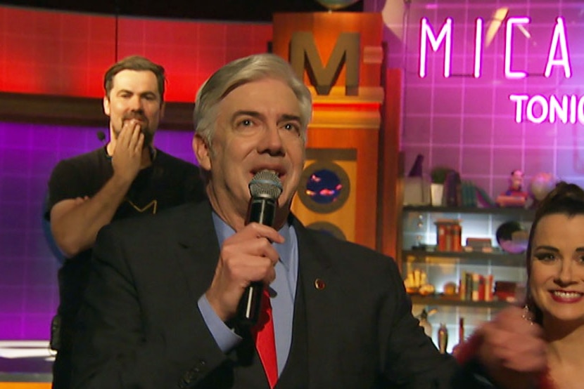 Shaun Micallef tearing up holding a microphone after the taping of his final program in Studio 31.