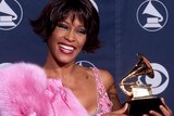 Pop diva Whitney Houston holds her Grammy award for Best Female Rhythm and Blues Vocal Performance