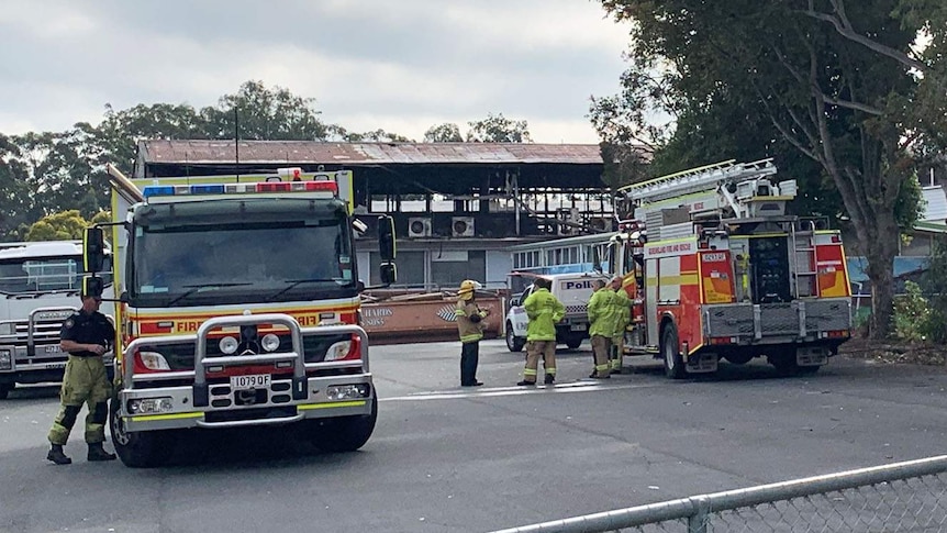 Firefighters at burnt out classrooms of Upper Mount Gravatt State School the morning after the fire.