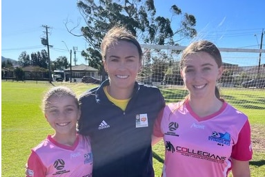 Two junior female soccer players with Caitlin Foord.