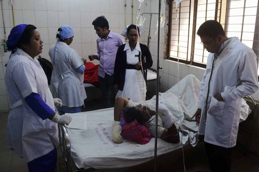 A Bangladeshi resident suffering burn injuries after a bomb attack on a bus is treated