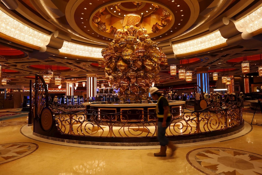Worker inside the incomplete Studio City casino, Macau