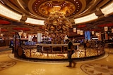 Worker inside the incomplete Studio City casino, Macau