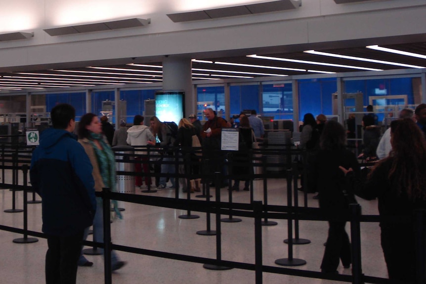 People join queues at John F. Kennedy airport.