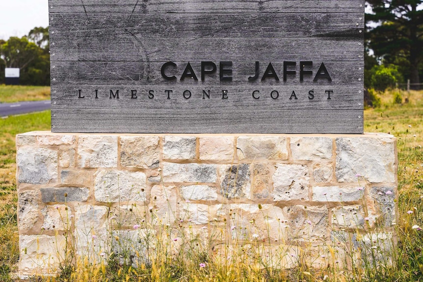 A sign with the words "Cape Jaffa, Limestone Coast" on top of a brickwork base.
