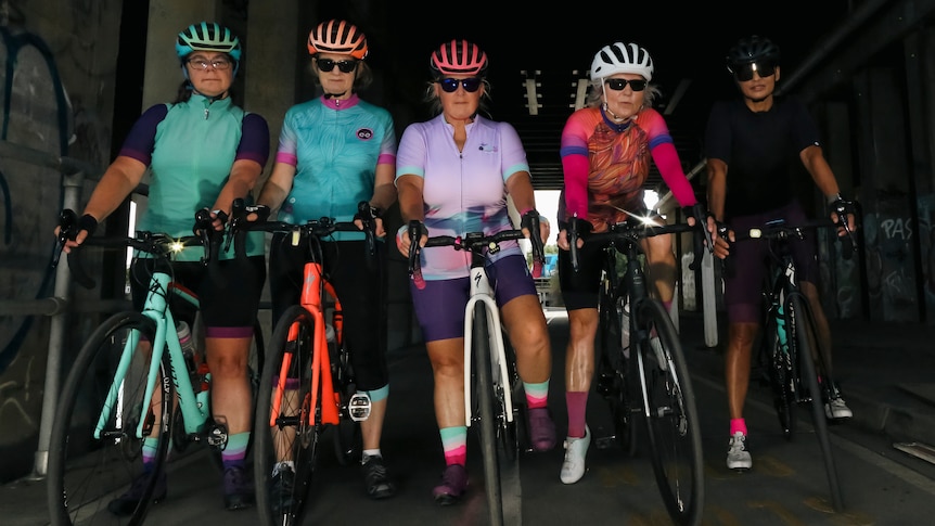 Five female cyclists side by side on a Melbourne bike path in a tunnel