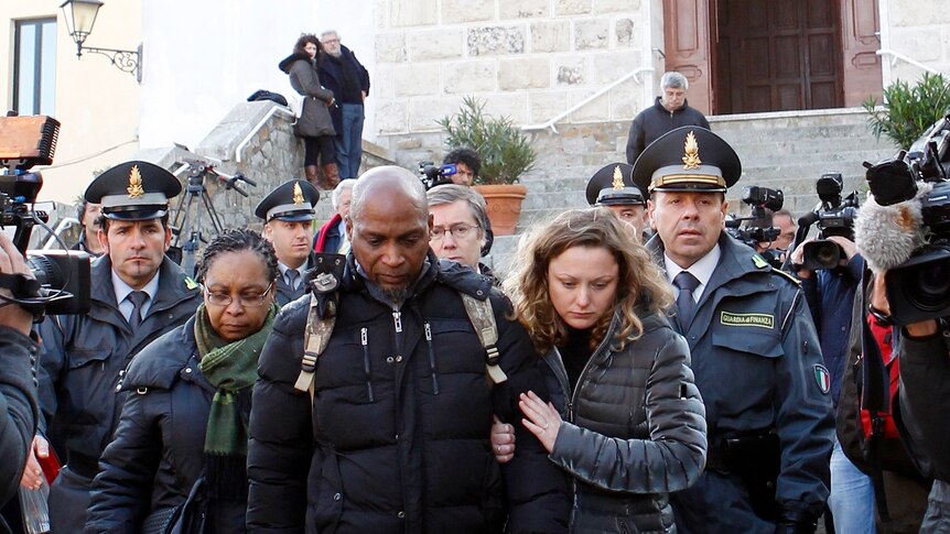 Relatives of the victims of the Costa Concordia cruise ship exit a church