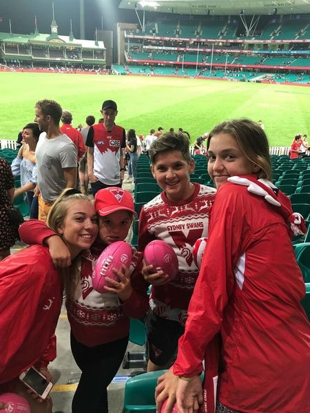A family dressed in red at a football ground