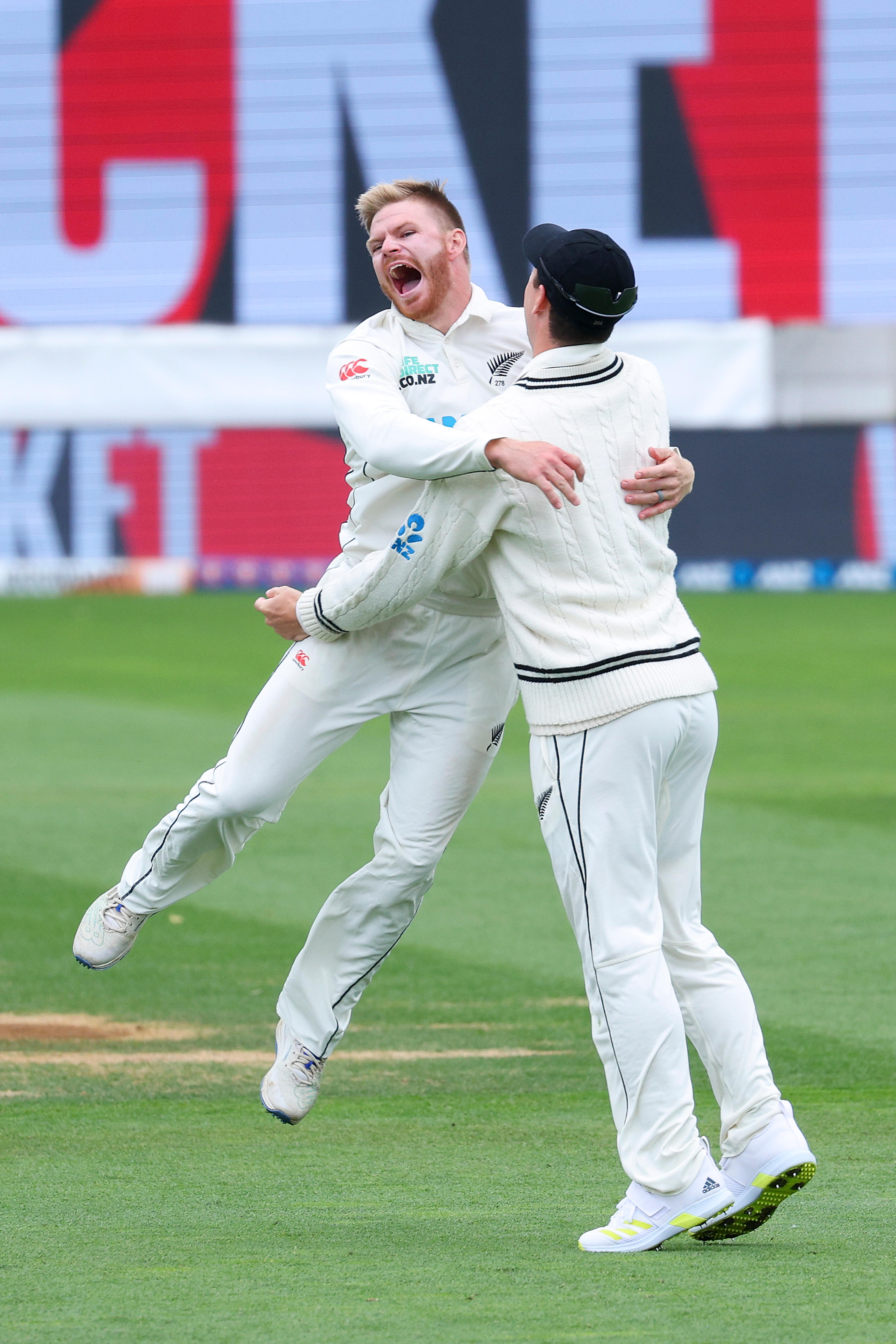 Glenn Phillips leaps into the arms of a teammate