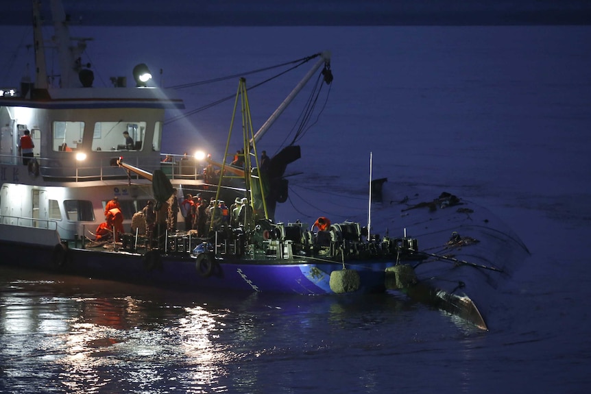 Rescue workers around the sunken ship