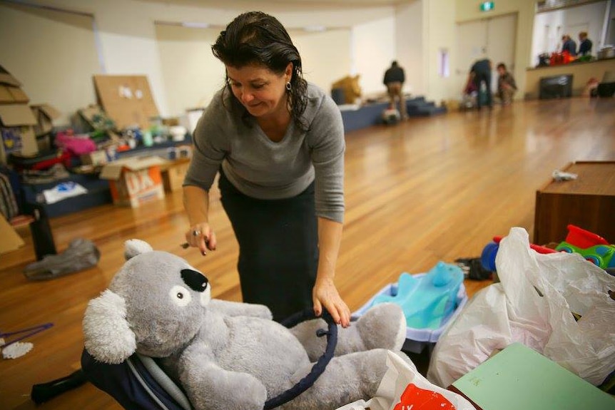A volunteer sorts donations at the Sunday Assembly Canberra's Refugee Housing Action Day