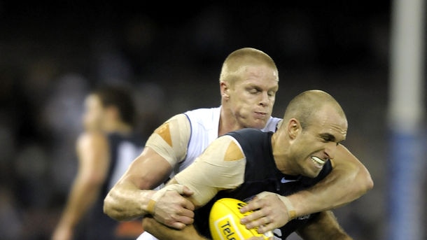 Undue attention ... Chris Judd gets tackled by Adam McPhee