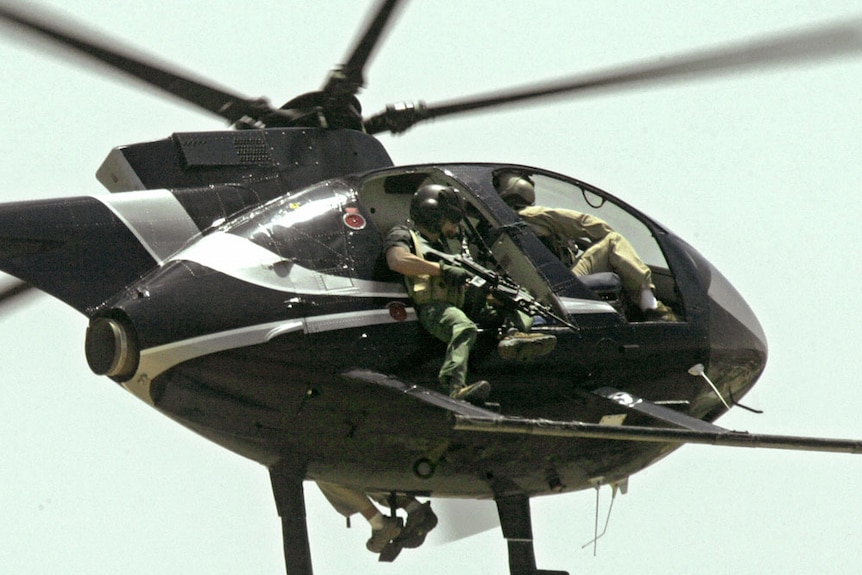 A helicopter with Blackwater private security company employees patrol Baghdad
