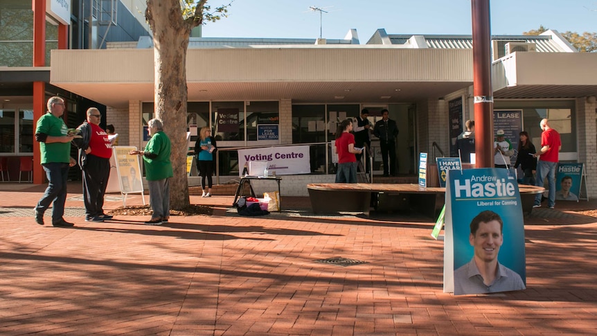 Party supporters hand out how-to-votes at Armadale's pre-polling station.