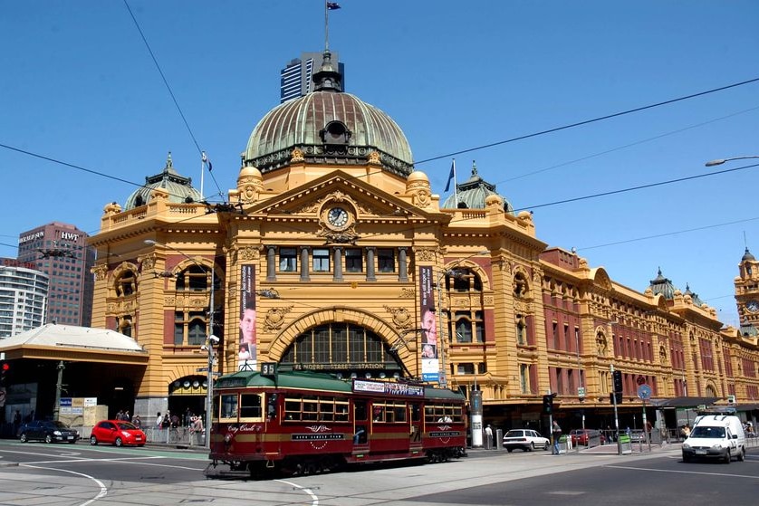 A tram passes Flinders Street Station.