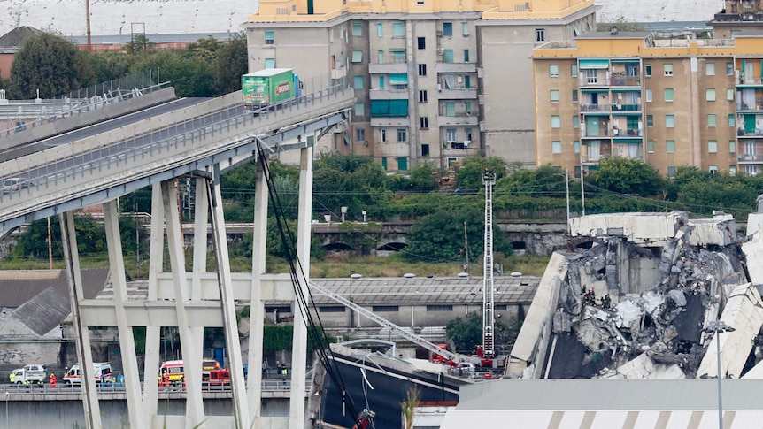 A wide shot shows a truck stopped right before a collapsed part of a bridge.