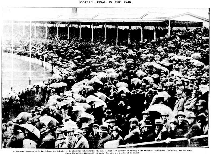 Black and white image lifted from an old news paper of a stadium filled with umbrellas.