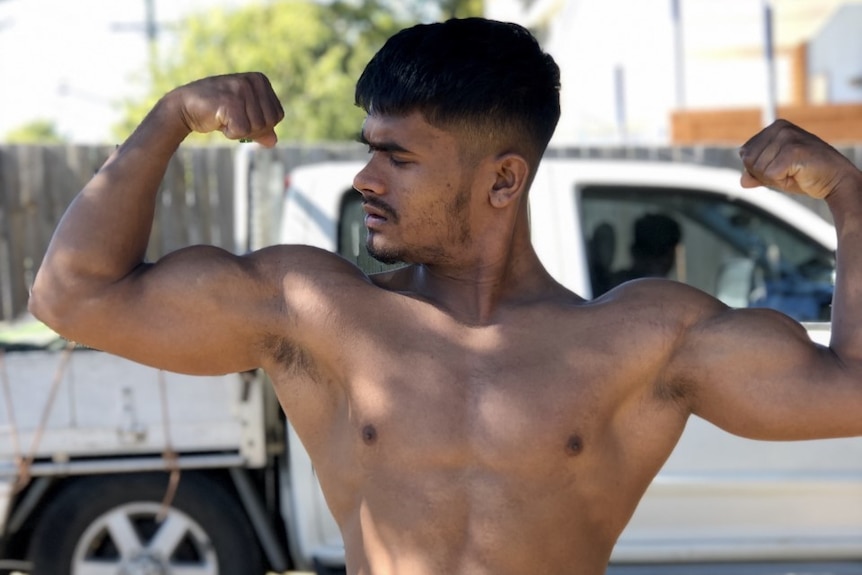 Noor flexes his muscles.