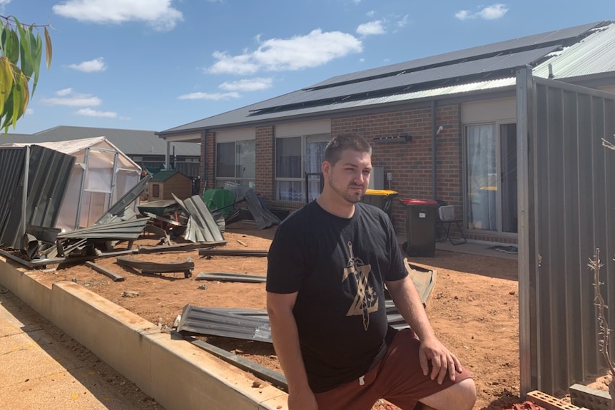 Isaac Shearing outside his home.