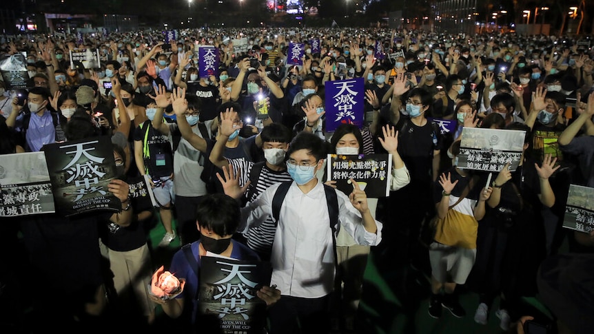 Hong Kong mourners gesture during a vigil for the victims of the 1989 Tiananmen Square Massacre