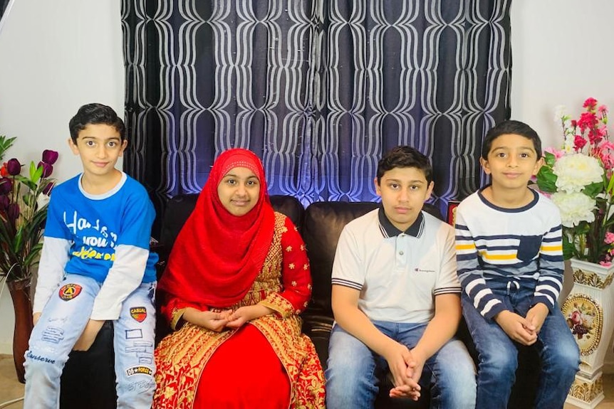 Hasan Razvi, Maryam Razvi, Hamza Razvi and Hussain Razvi sitting on a sofa in the family home.