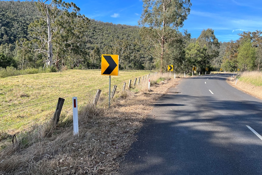 A barbed wire farm fence runs alongside the narrow Licola Road.