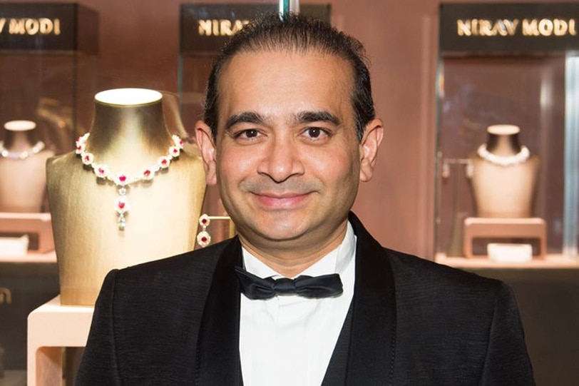 Nirav Modi stands in front of displays of jewels in one of his stores.