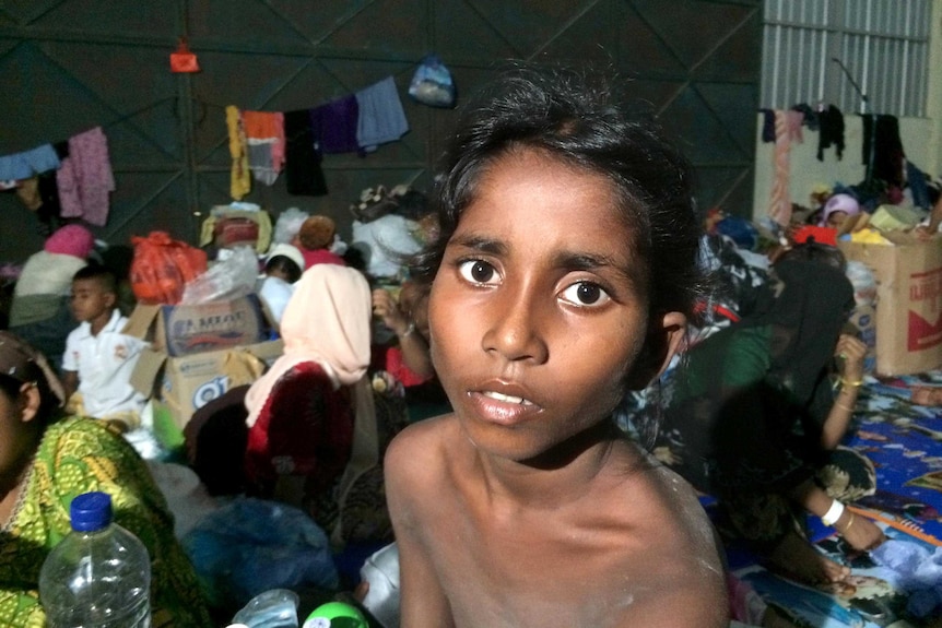 Girl sits in refugee camp