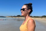Brianna Hurst wearing sunglasses looking out at the ocean. 