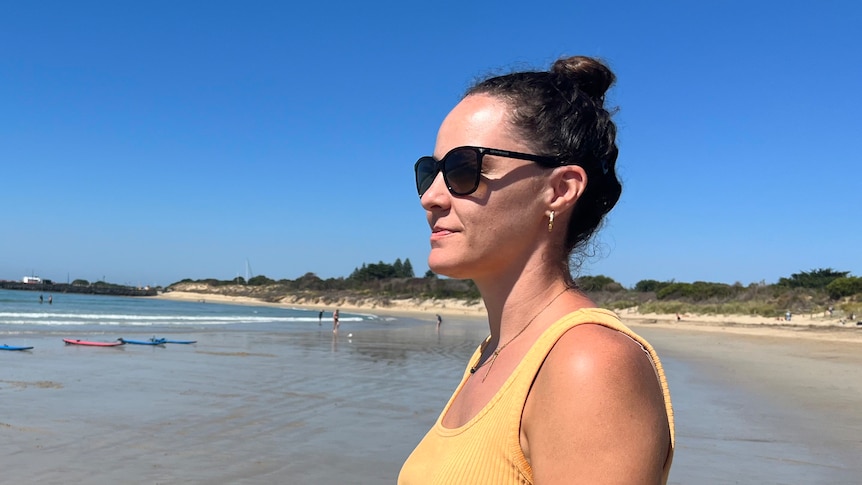 Brianna Hurst wearing sunglasses looking out at the ocean. 