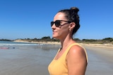 Brianna Hurst wearing sunglasses looking out at the ocean. 