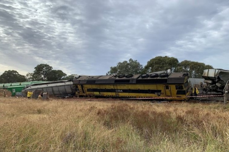 A derailed train in the countryside.