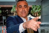 a man in a suit pointing