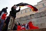 Greek anti-austerity protesters prepare to burn a German flag