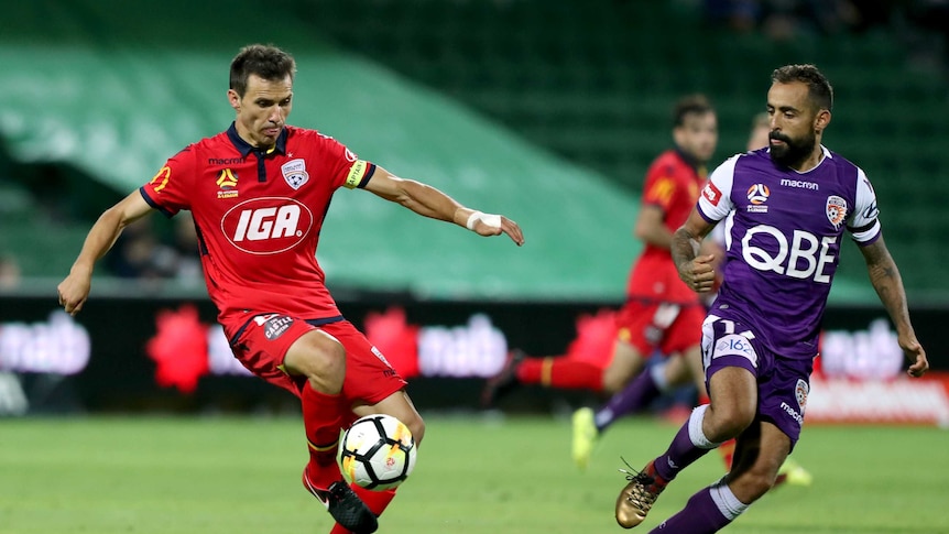 Isaias Sanchez (left) of the Adelaide United controls the ball during an a-league game