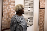 A photo of Janet Marawarr at an exhibition opening in Sydney.